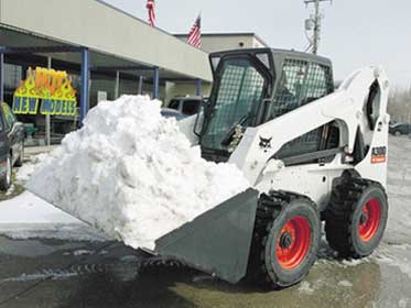 Bobcat plowing snow.